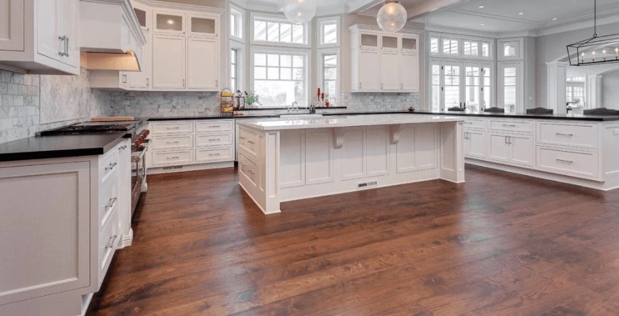 Kitchen wood flooring in dark stained oak around a white island