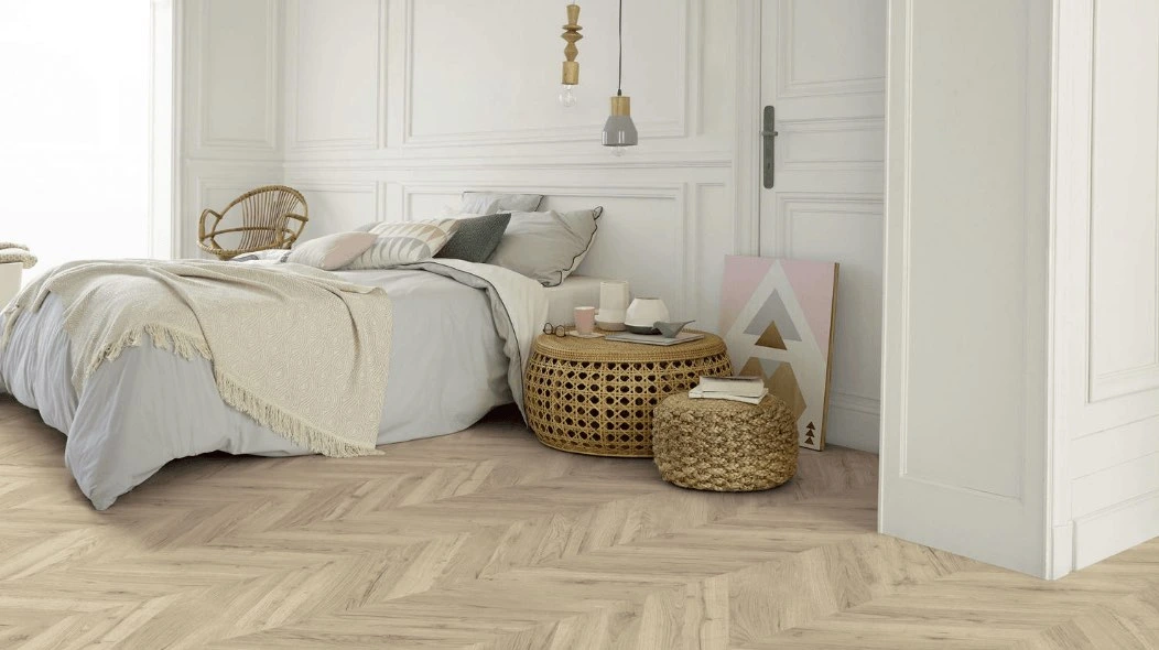 Bedroom wood flooring laid in a light oak herringbone pattern