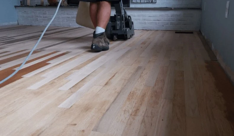 Applying a fresh finish coat during a screen-and-recoat on white oak flooring